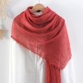 Solid red pleated cotton linen scarf with frayed edges styled over a white shirt - Red