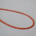 S925 silver necklace with orange-red square gemstone beads on grey fabric back - 2.2mm Natural Southern Red Agate Square Bead Necklace