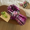 Detailed view of soft plaid scarf with tassels on wooden table with cozy lifestyle props - Purple Plaid