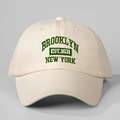 Detailed close-up of green Brooklyn embroidery on cream cotton twill baseball cap - One Size / Beige