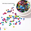 Detailed macro view of 3mm colorful heart-shaped laser sequins for nail art decoration - Colorful