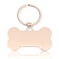 Detailed macro view of bone-shaped rose gold stainless steel pet tag with smooth finish - Small Rose Gold Bone Pendant Keychain