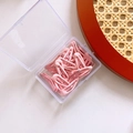 Detail of pink metal snap hair clips stored in a clear rectangular plastic organizer box - Pink Series Waterdrop