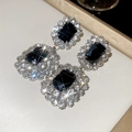Detailed macro view of vintage oval pendant earrings with blue crystals and silver rhinestones - Clip-on Style (Black-Silver)