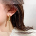 Elegant gold drop earrings featuring five graduated metal beads on model - Graduated Gold Five Beads