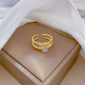 Detailed top view of gold bow ring with sparkling zircons on soft white silk lining - Adjustable Open / Gold (R134)