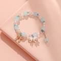 Handmade beaded bracelet with light blue beads, pink pearls, and a golden bow pendant - S018-blue Bow Lily Of The Valley Bracelet #sz187
