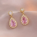 Pink pear-cut zircon teardrop earrings with halo design on soft pink silk fabric - Pink Teardrop Zirconia Pendant Style (E1117)