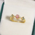 Macro view of gold flower ring with pink oval stone and colorful zircon in jewelry box - Pink Oval Gemstone with Multicolor Zirconia Style (金色14)