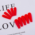 Detailed view of matte red coffin press-on nails with smooth frosted texture surface - True Red
