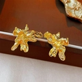 Artistic gold C-shaped heart earrings with irregular lava texture and metallic finish - Gold Wrinkled Flower