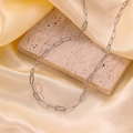 Textured silver Cuban link chain necklace displayed on a beige stone with silk - H6125 Embossed Simple Chain Necklace Steel
