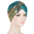 Deep green sequined turban for women featuring golden glitter patterns on a white background - Teal