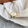 Golden butterfly ring with blue-green enamel wings and a centered pearl accent - Blue Green Gradient Butterfly Pearl Adjustable Ring(NL00760R-BU)