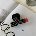 Cute pencil-shaped acetate hair claw clip in candy colors on an open book - Black Pencil Shape / Black