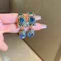 Macro detail of vintage gold drop earrings with blue and green crystals and tassels - 12# Ear Clip-Antique Gold-Blue