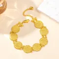 Detailed view of golden coin bracelet with embossed portrait charms and a heart pendant - 8-Coin Bracelet