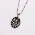 Macro shot of silver stainless steel Saint Benedict pendant with relief carving detail - With Chain / Antique Silver
