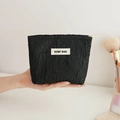 Handheld black quilted floral makeup bag with rose jacquard pattern and beige label - Small Black Jacquard Bag