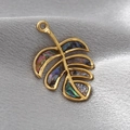 Golden leaf pendant with natural abalone shell inlay on elegant silk background - Abalone Monstera Leaf