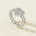 Macro detail of silver heart ring with pavé zircons and woven chain band structure - Style 6