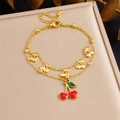 Detail of gold double-layer bracelet with red enamel cherry charms and adjustable chain - Cherry Style (B1708)