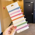 Set of 7 colorful matte hair clips in pastel rainbow tones on a white display card - Slender Rectangular 7-Piece Set