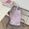 Detail of lavender canvas tote bag with grocery floral print on a chrome chair - Purple