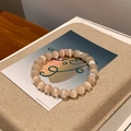 Cat eye stone beaded bracelet with silver metal spacers on a white artistic display card - Beige (Cat's Eye)
