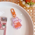 Porte-clés ours en acrylique avec clip orange et motif violet pour sacs à dos - Ours en tablier