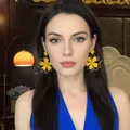 Close-up of model wearing yellow floral petal drop earrings with gold edge detail - Gold/Yellow (11# Silver Needle)