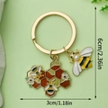 Golden honeycomb and bee keychain with pearl charm and dimensions 6cm by 3cm - Artificial Pearl Bee Honeycomb