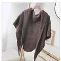 Close-up of dark brown knitted poncho with elegant leather buckle detail on hanger - Triangle Style / Mocha