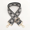 Close-up of ethnic geometric jacquard woven strap with golden metal lobster clasps - Black White Grey