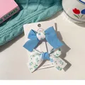 Blue and floral fabric bow hair clips for girls, set of two on white display card - Blue Patchwork Bow Set