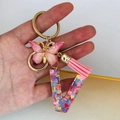 Pink resin letter V keychain with glitter hearts, butterfly charm and tassel - Butterfly Tassel 8-Shape Buckle / Letter V