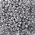 Macro shot of silver round acrylic alphabet beads for DIY creative jewelry making - 4x7mm Antique Silver Letters (100pcs)