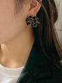 Detail of vintage square zircon flower earrings with gold outline worn by a model - Black