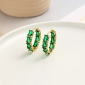 Macro view of gold hoop earrings featuring emerald-cut green zircon in a claw setting - Green (ZYN-DME454G-1)