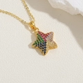 Macro shot of gold star pendant inlaid with colorful zircon stones on white marble - Colorful Zirconia (XL2593-3) / 14K Gold