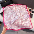 Detailed view of lightweight silk scarf with pink starfish and shell print on white base - 70*70cm / Pink Marine Life