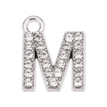Detail of silver letter M pendant encrusted with sparkling white rhinestones for jewelry - M