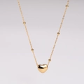 Close-up of golden heart pendant necklace with small bead accents on a fine chain - Heart Beaded Chain Necklace / Gold (Necklace)