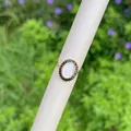 Detailed macro view of 18K gold ring with Virgin Mary relief and black square zircon inlay - Black