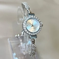 Silver quartz watch with rhinestone encrusted bezel and bracelet on display stand - Silver