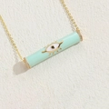 Mint green evil eye cylinder necklace with gold chain and cubic zirconia accents - Light Blue