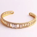 Detailed macro view of gold-plated hollow chain bracelet with emerald-cut cubic zirconia - White Zirconia