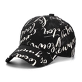 Detail of black baseball cap featuring white cursive script printing and cotton texture - Black