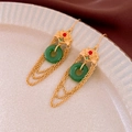 Detailed view of traditional Chinese gold tassel earrings with green jade pendant - Green Faux Jade Tassel Ear Hook
