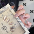 Press-on nail set with nude cat-eye finish, black bows and rhinestones on long oval nails - By1680 Spotted Bow Tie / Glue Type